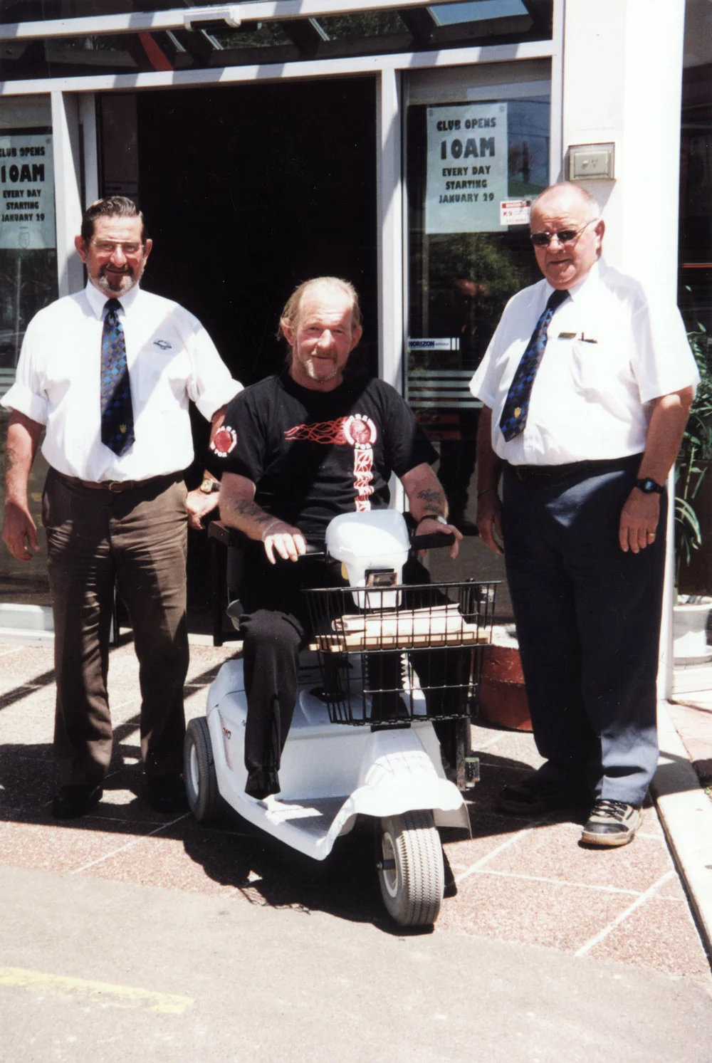 Cosmopolitan Club; mobility scooter for members; Laurie Grant, Dick Crane, Ron Woolford.