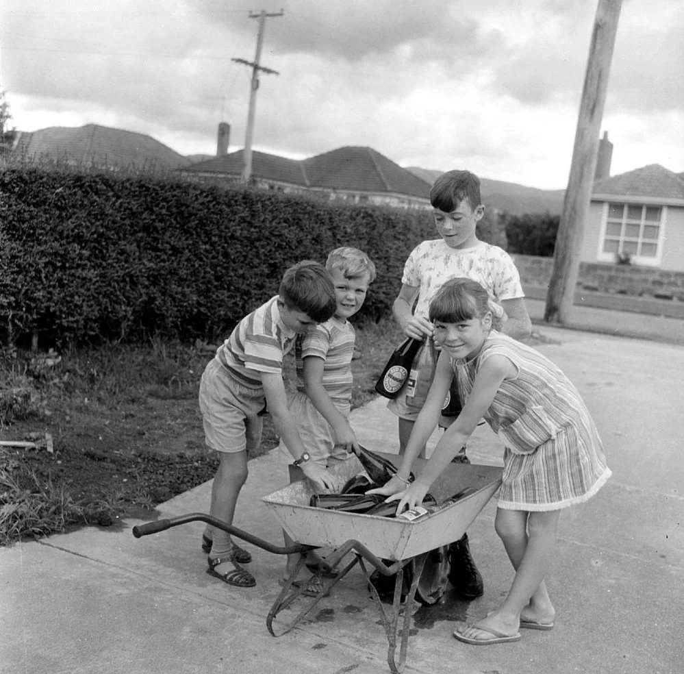 Molony children and wheelbarrow, collecting bottles.