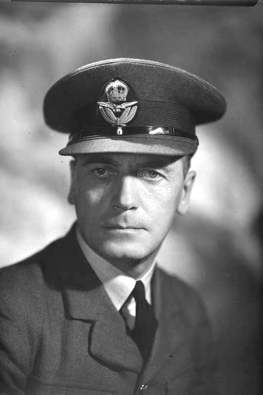 Head and shoulders portrait of Flying Officer G Baldwin from R N Z A F, in military uniform
