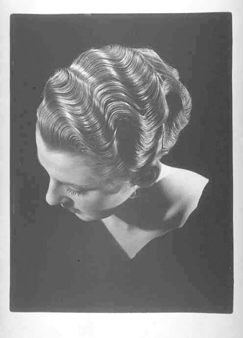 Head and shoulders portrait of unidentified woman showing hairstyle
