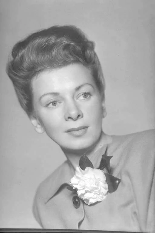 Head and shoulders portrait of Mrs L J Warren, modelling for Bobby Angus Gowns in Queen Street