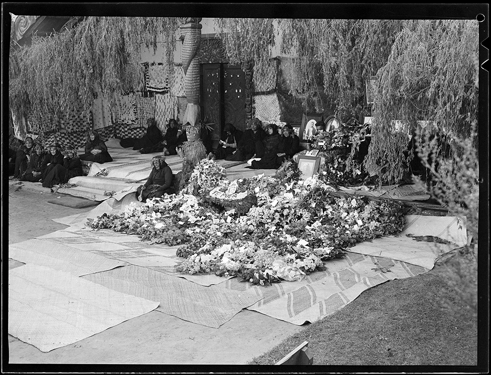 Women on porch with wreaths & coffin