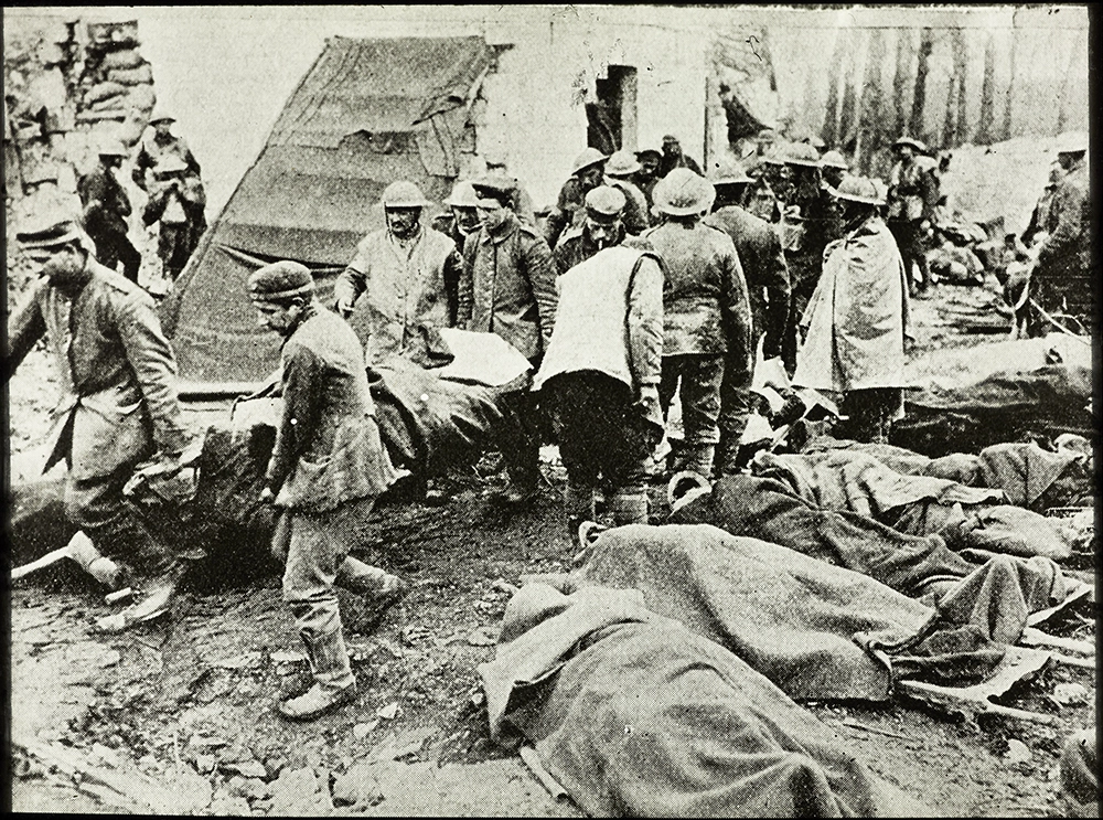 Soldiers carrying Wounded soldiers on stretchers, probably at a field hospital or triage station on the Western Front