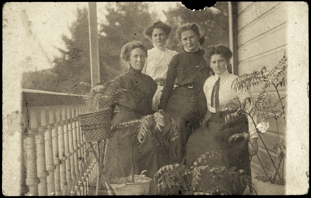 Four unidentified women sitting on a verandah