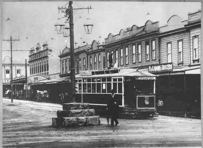 Showing a gentleman standing in front of Three Lamps in....