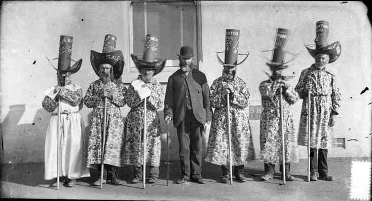 Employees of W H Fenton and Company, hat manufacturer, in fancy dress and caricature hats advertising a sale...1889