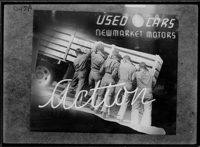 Showing men loading a neon sign for Newmarket Motors into a truck, for Rayneon, 1941