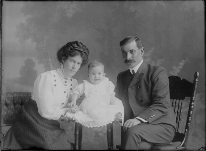 3/4 length portrait of the Parris family group, the man seated....
