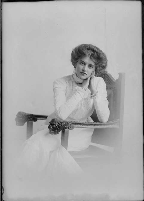 3/4 length portrait of Miss Walters, seated in a wooden chair....