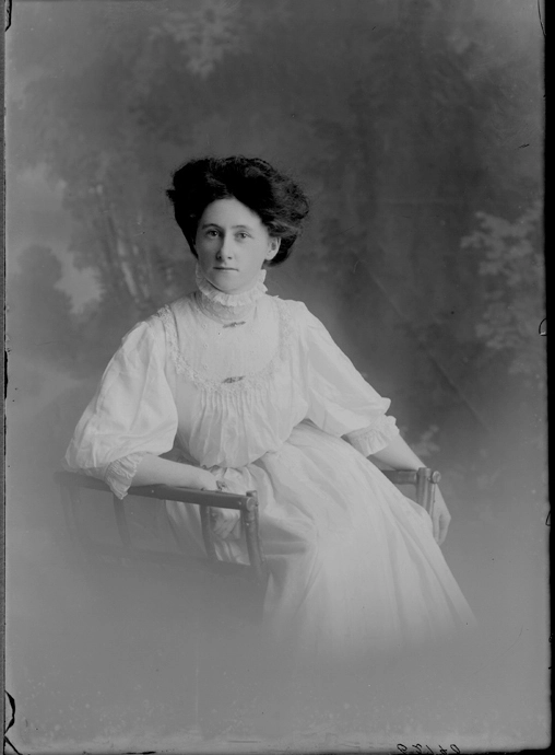 3/4 length portrait of Miss Kearney, seated in wooden chair,....