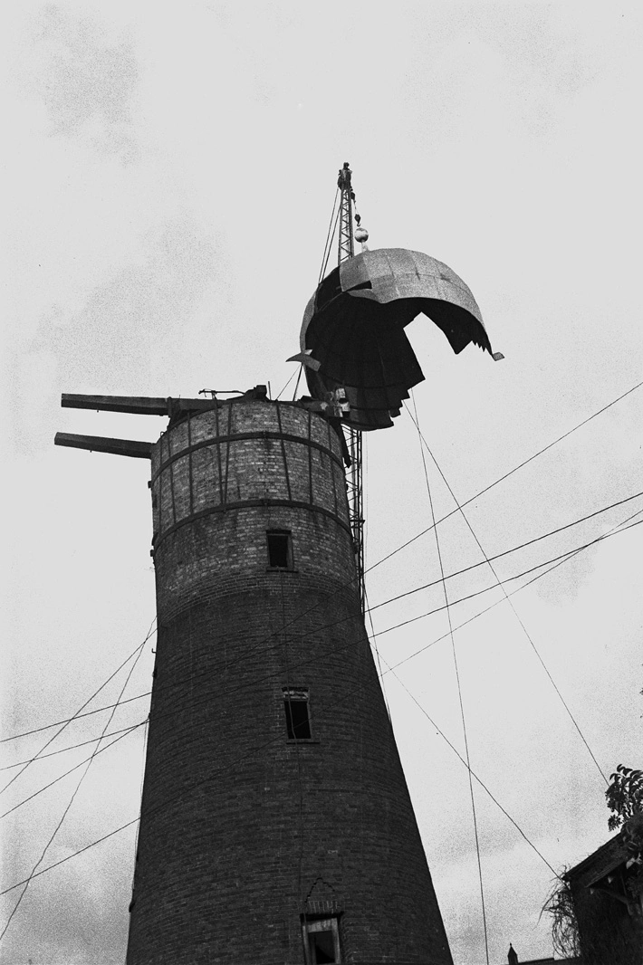 Showing the revolving metal cap of Partington's windmill being...