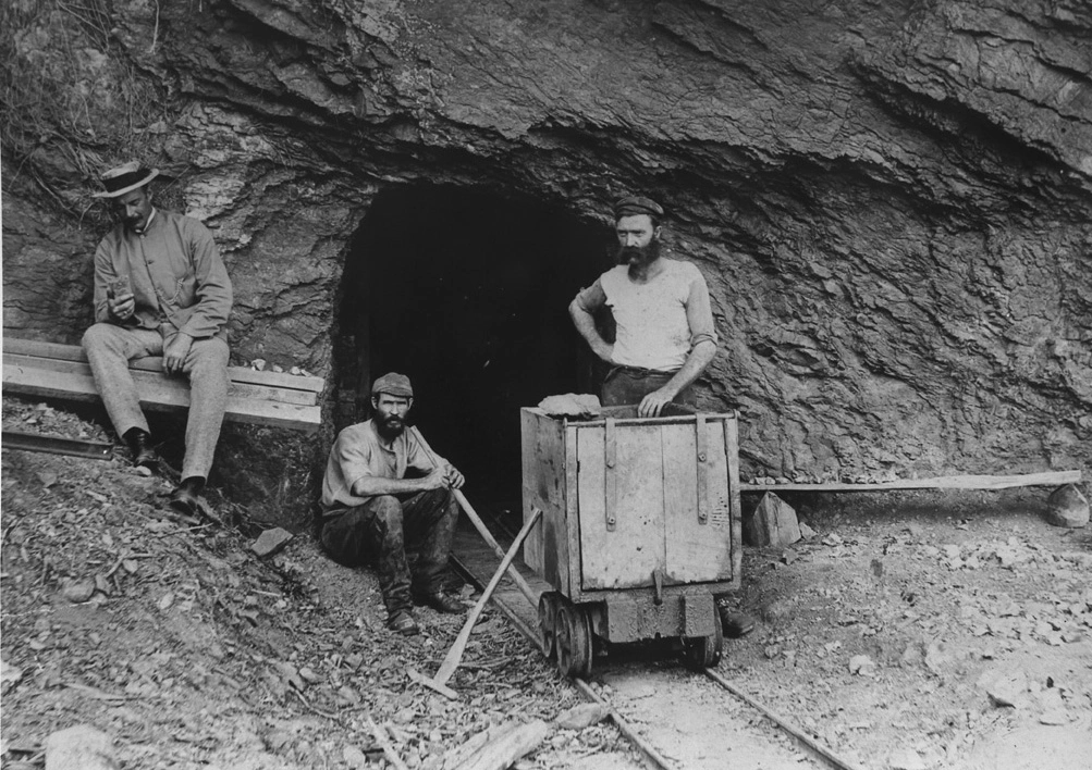 Captain Holgate and 2 miners outside a copper mine on Kawau Island