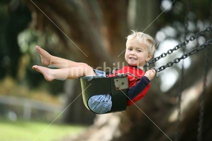 a young boy enjoys a swing