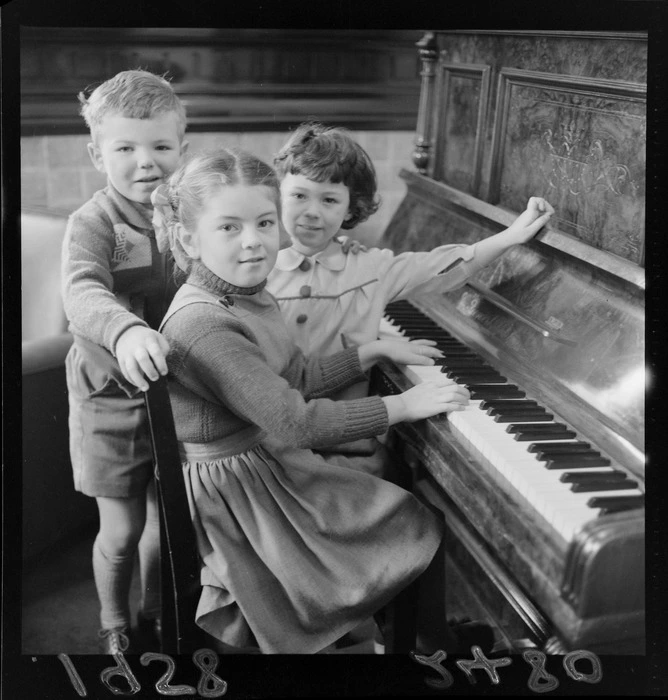 Unidentified Russian children playing on a piano at the Russian Embassy, Wellington