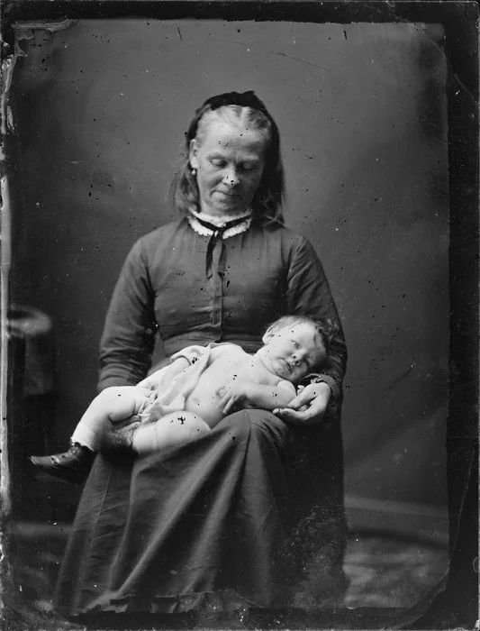 Unidentified woman and a baby