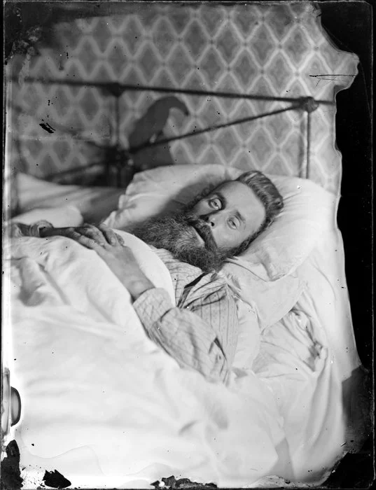 Unidentified man, sick in bed