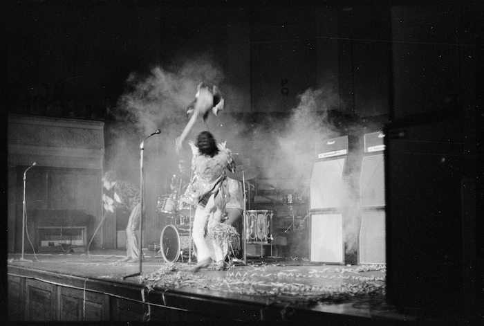 Pete Townshend, throwing his guitar in the air while performing a concert with other members of The Who in Wellington