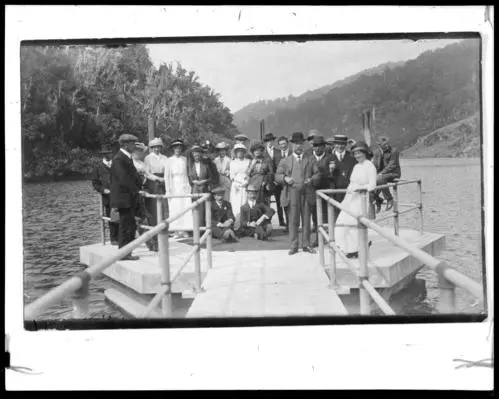 Group of people with Morton Dam in background, Wainuiomata