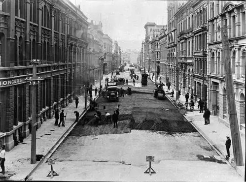 Elevated view of Victoria Street with alsphatic concrete paving in progress, number of workmen and equipment, Victoria Street, March 1926