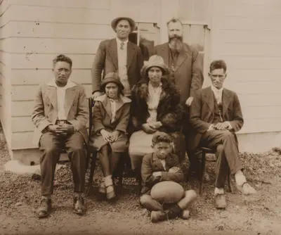 (Group portrait of Gilbert Family with Father van Beek)