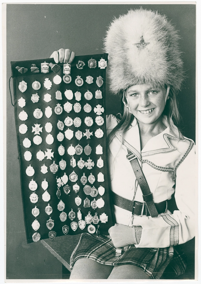 Jackie Sibley, marching team leader, with medals