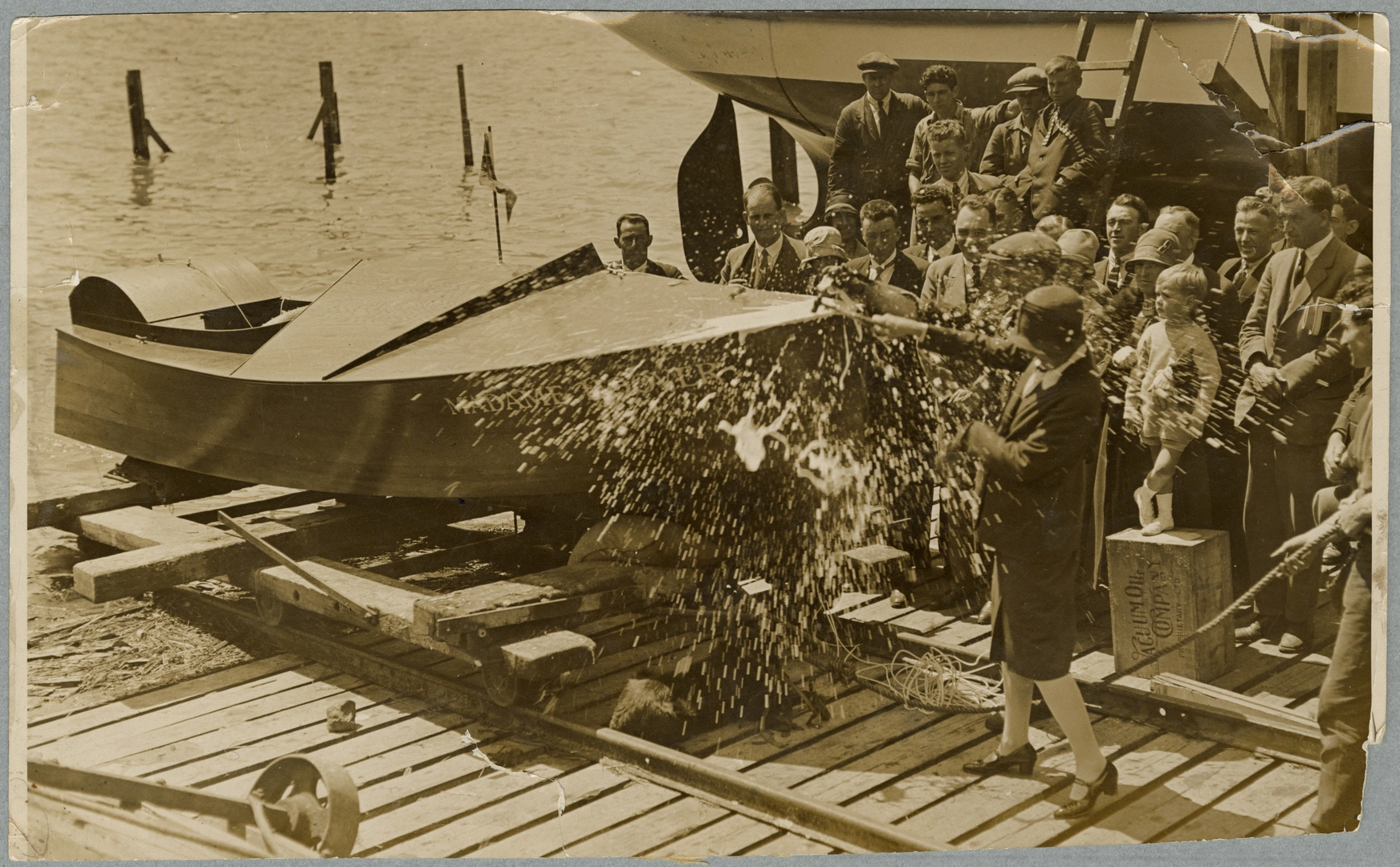 Mrs Elizabeth McCombs christening a motorboat