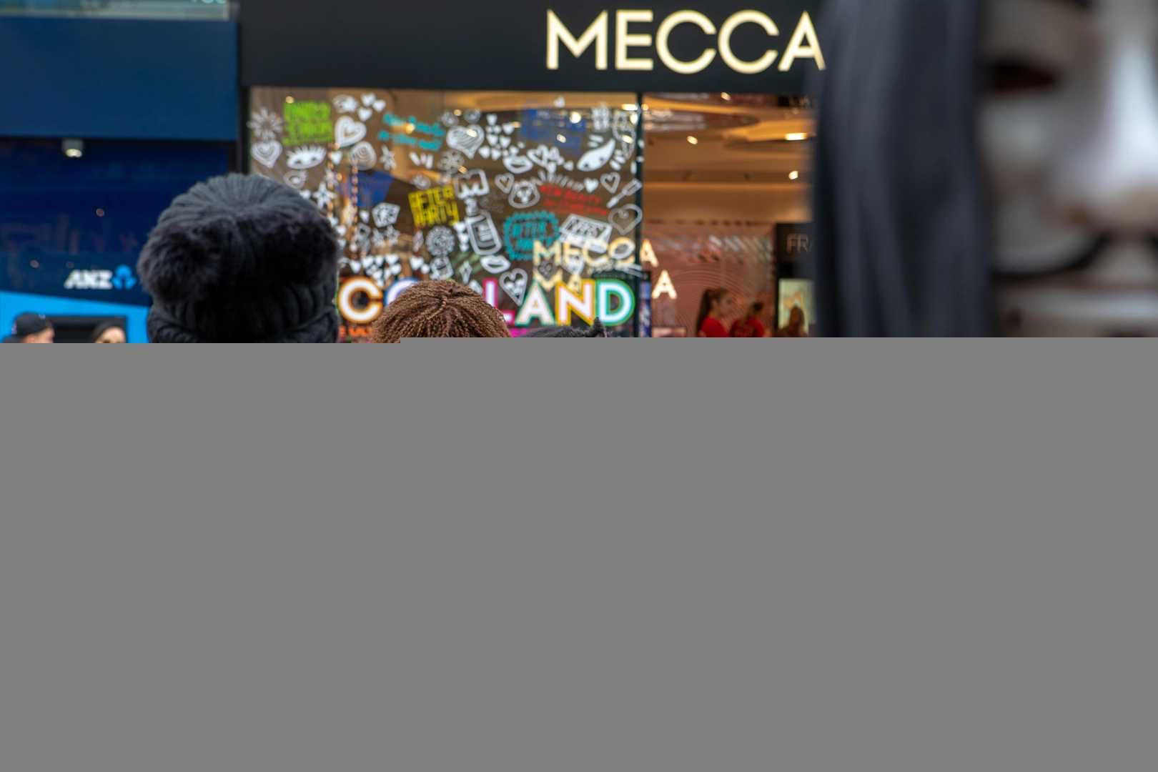 Woman and child watching protest by Anonymous for the Voiceless, Cashel Street