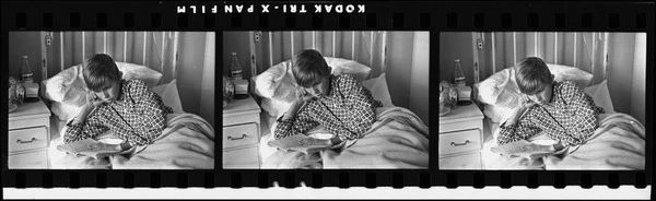 Michael O'Connor reading in hospital bed