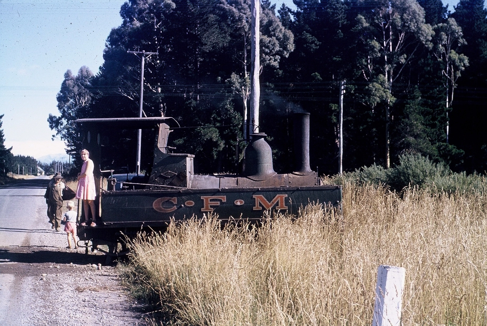 Jennifer Robinson standing on the “coffee pot” steam engine