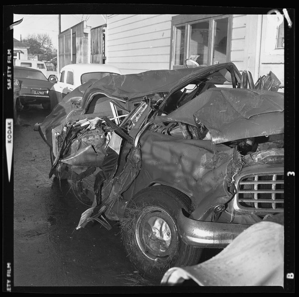 Damaged car with grass clogged around the hubcap