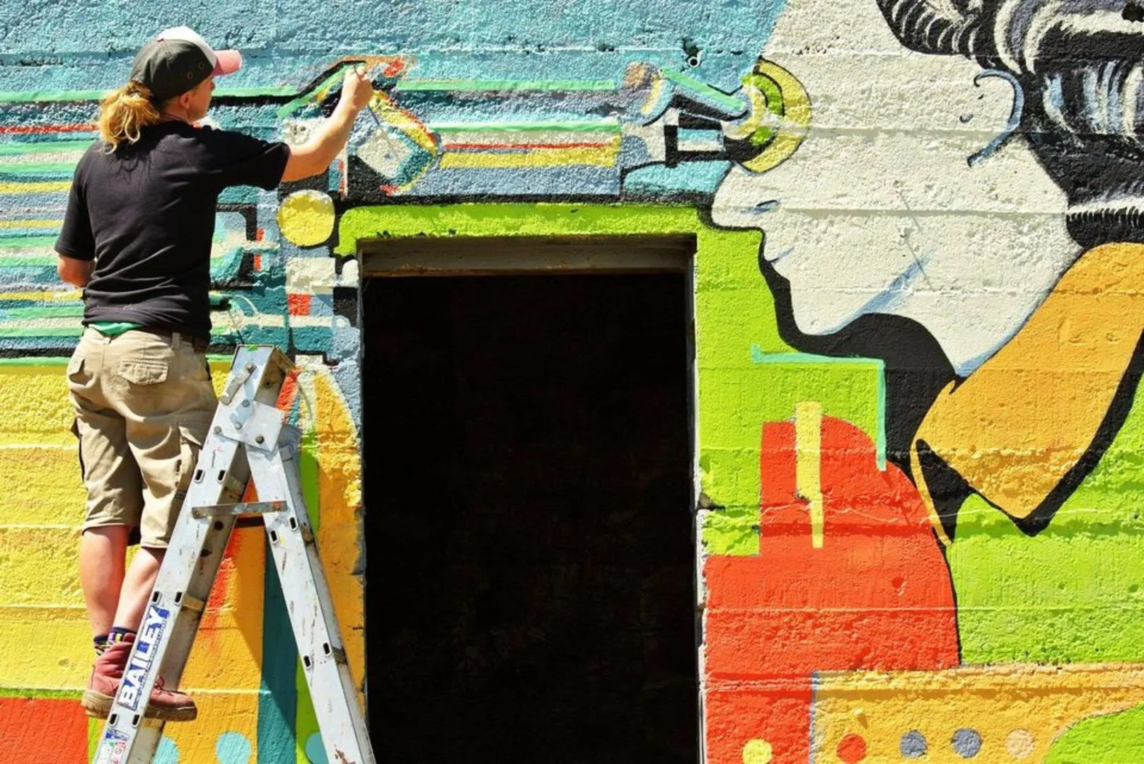 Bridget Allen painting her mural - Godley Head Guard House