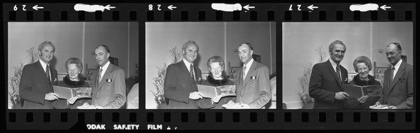 Mr Belich, Doreen Grant, and R. P. B. Drayton with a book