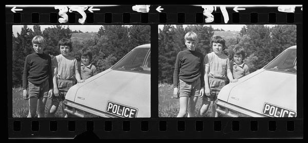 John Patrick, Kent and Blair Brownlee beside police car