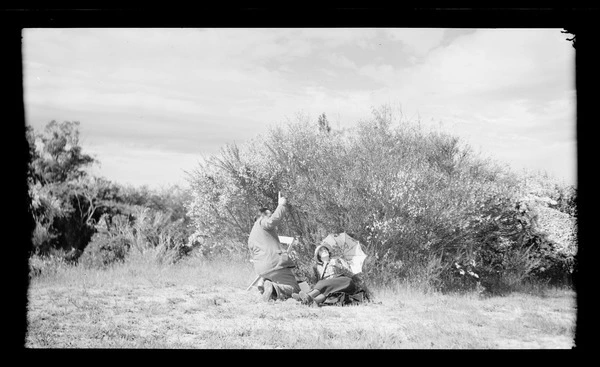 Frank and Sylvia Vinicombe sitting beside a bush