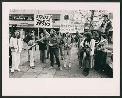 [Christian protesters sing in an outdoor shopping centre]