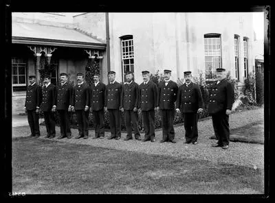 [Group portrait of male attendants in lined formation, Avondale Lunatic Asylum]