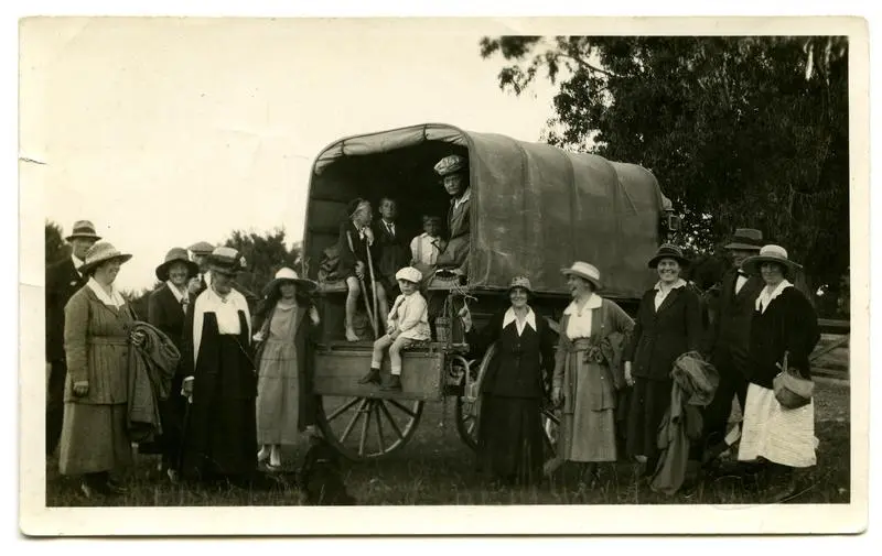 Photograph, Black and White: Lovell-Smith family group standing beside a covered wagon.