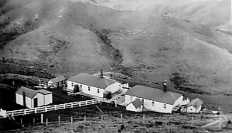 Photograph: Two houses in a valley at Pencarrow