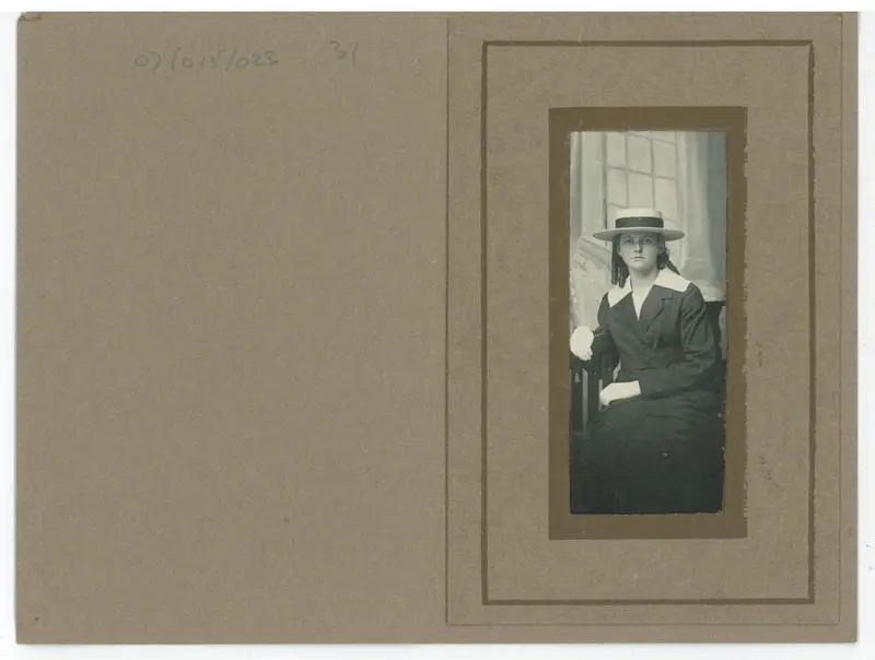 Studio portrait of a seated teenage girl in school uniform