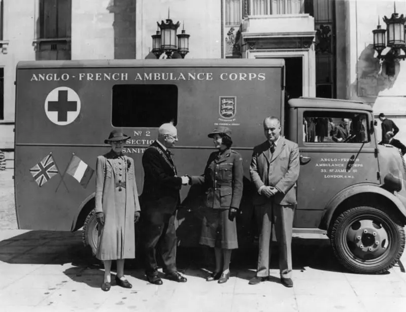 Jean Batten and three unidentified people on the occasion the Ambulance Trust Fund presented new ambulances to the L C C and Anglo-French Ambulance Corps