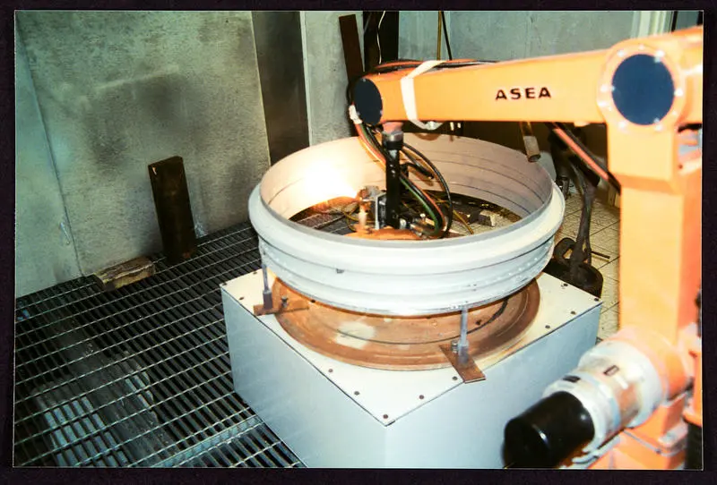 Photograph of ASEA robotic arm in action