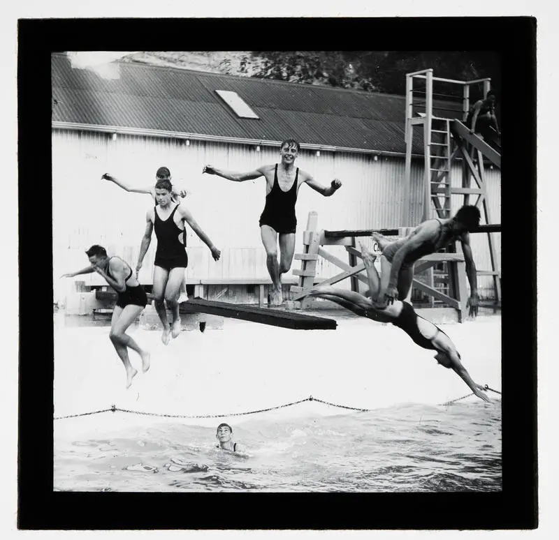 Unidentified people jumping off a diving board