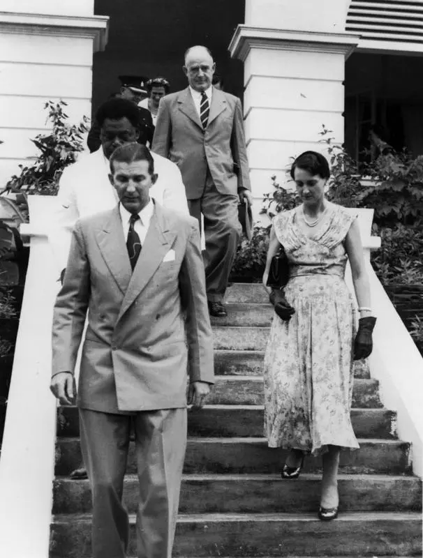 Photograph of John Wisdom and Geoff Roberts with four other people wakling down some steps