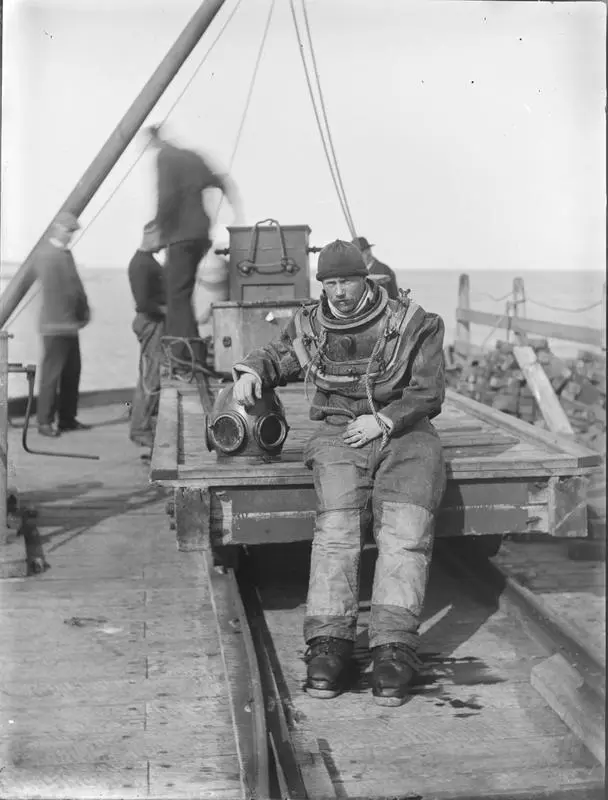 William Hearn in diving suit, Opunake wharf