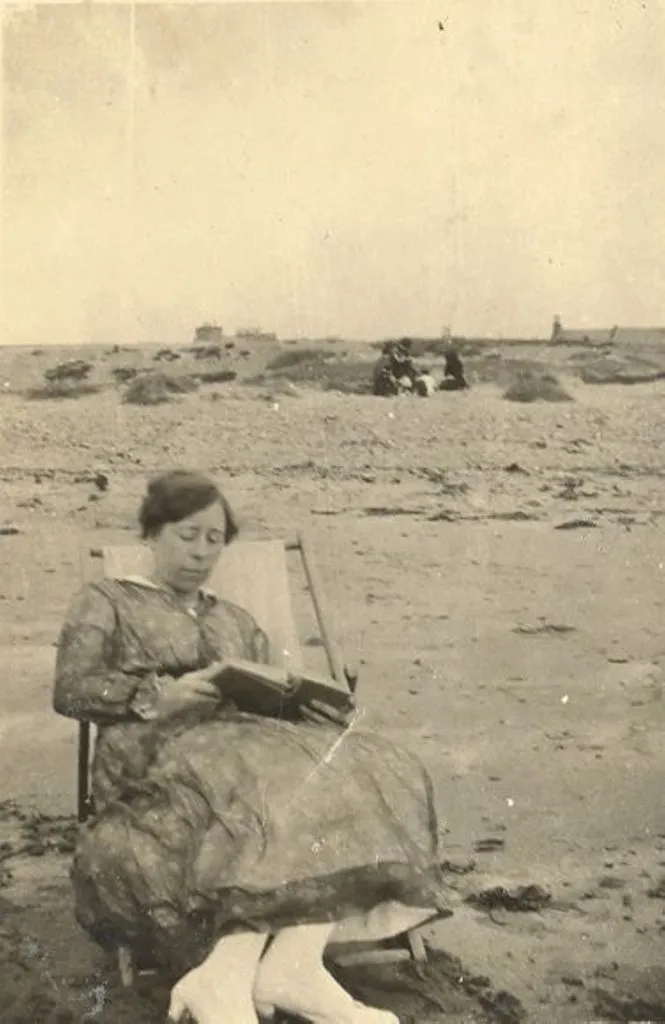 Lady reading a book at the beach