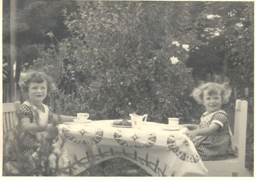 Two unidentified girls having a tea party
