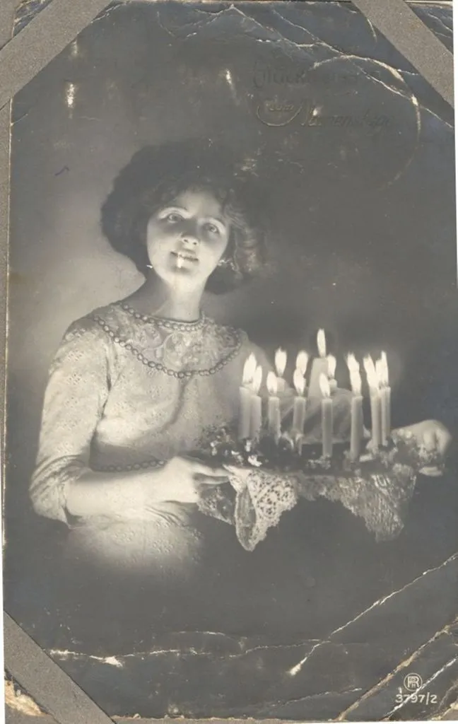 Young woman with birthday cake. c1914-18.