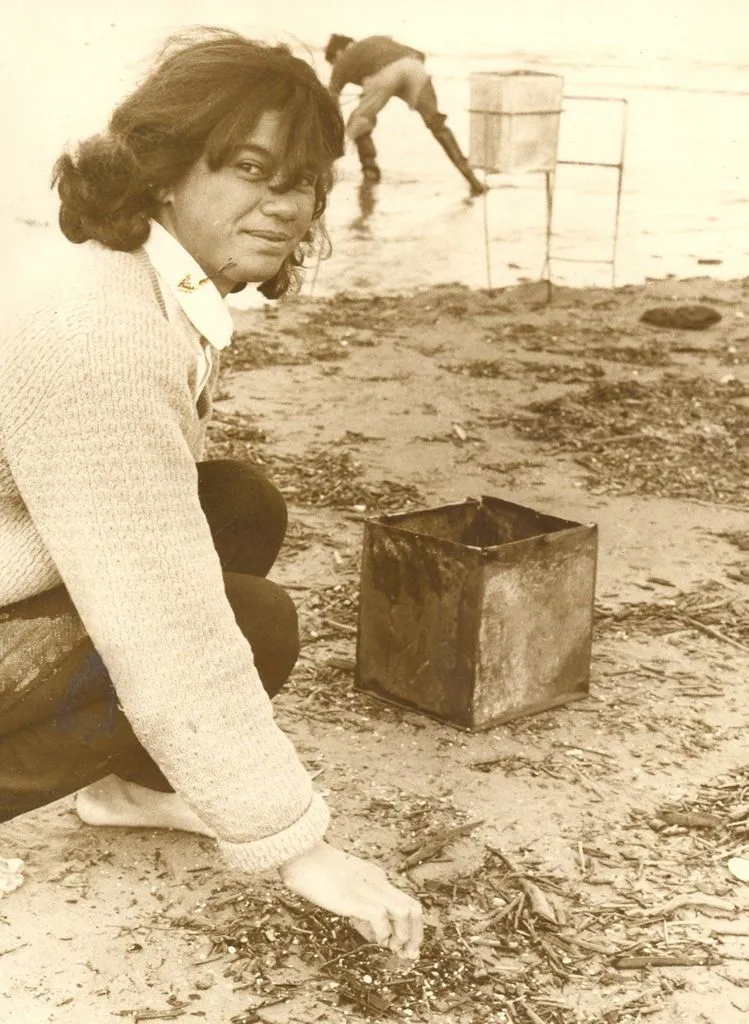 Mona Williams sorts whitebait from rubbish in her catch, 1969