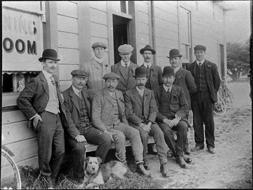 Group of men and dog outside a Public House