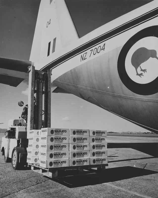 Cases of Waikato Strong Ale being loaded onto an aircraft